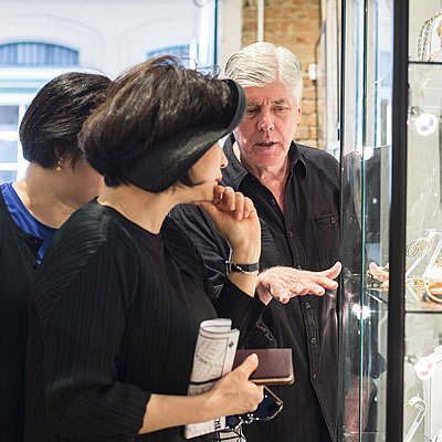 employees looking at jewelry case