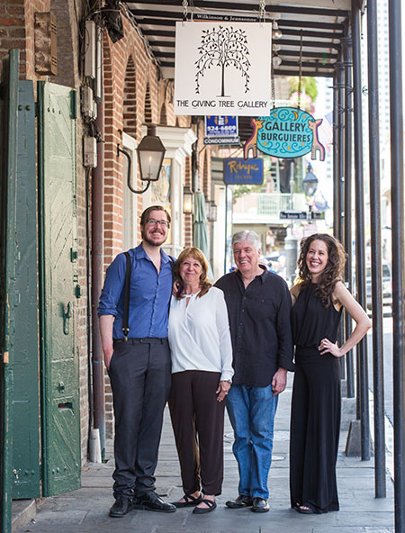 Employees standing outside under store sign